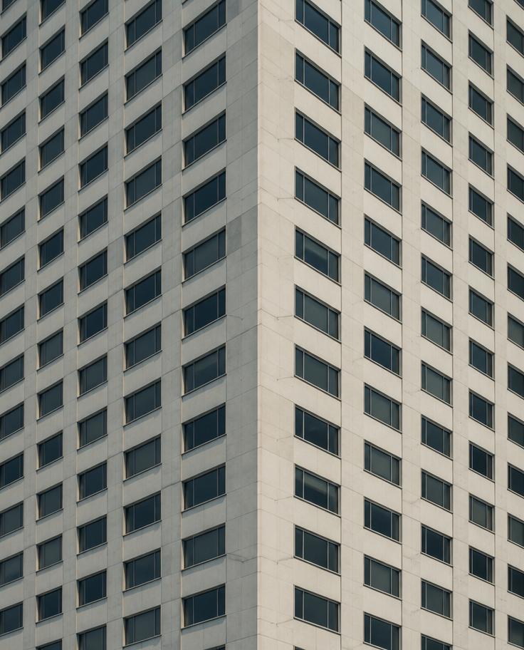 Concrete tower facade with repetitive window grid