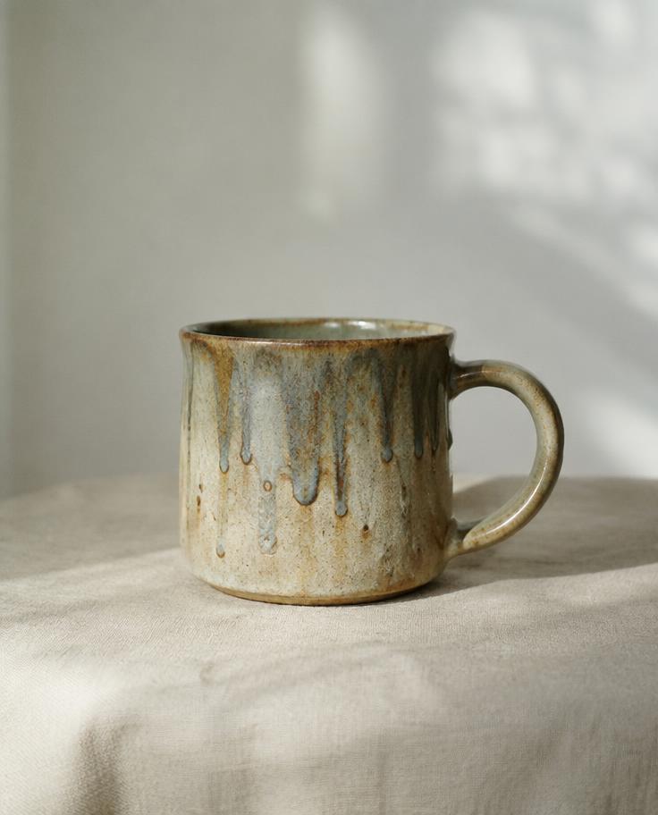Handmade ceramic mug with glaze drips